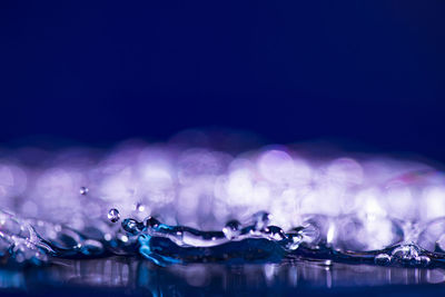 Close-up of water splashing against blue background