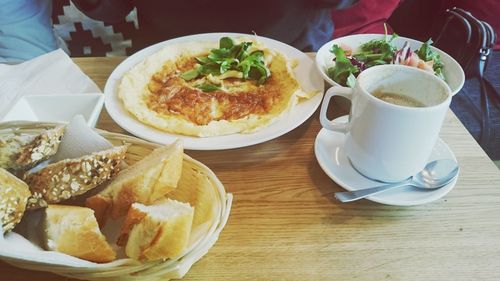 High angle view of coffee with snacks served on table