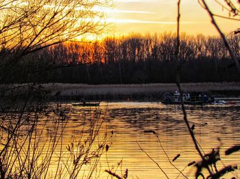 Scenic view of lake against orange sky