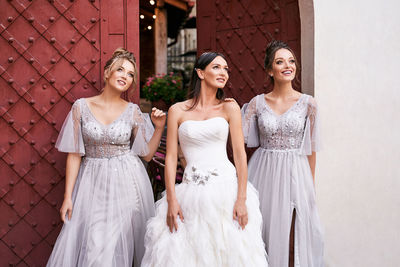 Portrait of bride standing against wall