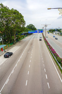 Cars on street against sky