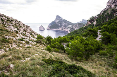 Scenic view of sea and mountains against sky