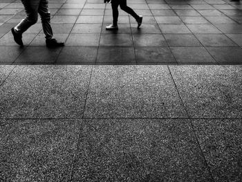 Low section of people walking on footpath