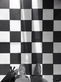 Low section of woman walking on tiled floor