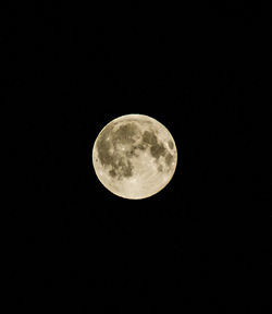 Low angle view of moon against clear sky at night