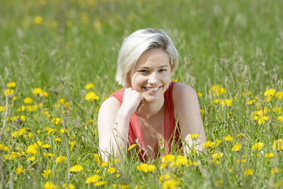 Portrait of a smiling young woman on field