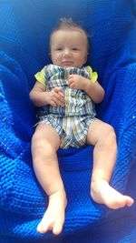 High angle view of cute baby boy on bed