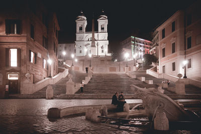 People in illuminated building at night