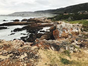 Scenic view of rocks in sea against sky