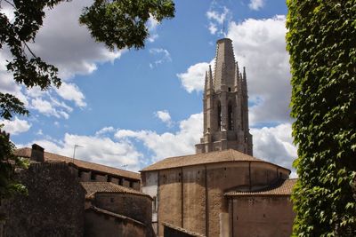 Low angle view of church against cloudy sky