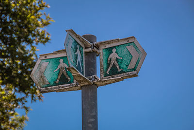 Low angle view of a street sign against blue sky