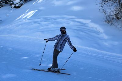 Full length of man skiing on snowy field