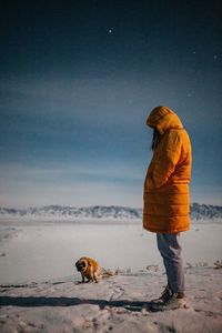 Rear view of a dog on snow covered land