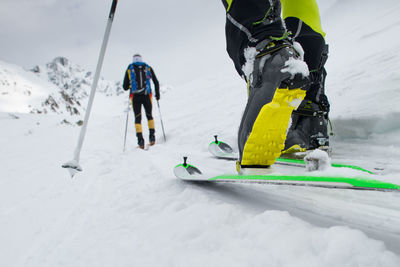 People skiing on snow covered mountain