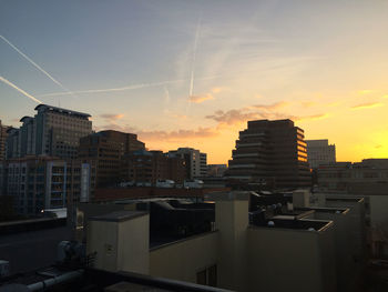 Buildings in city at sunset