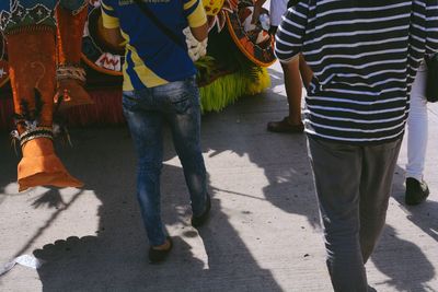 Low section of man walking on footpath