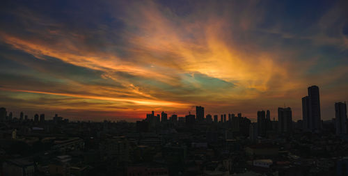 Buildings against sky during sunset