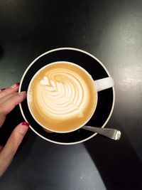 Close-up of hand holding coffee cup