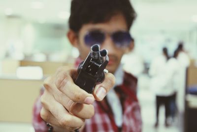Close-up of man holding handgun