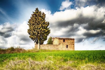 Built structure on field against sky