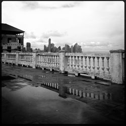 Buildings in city against cloudy sky