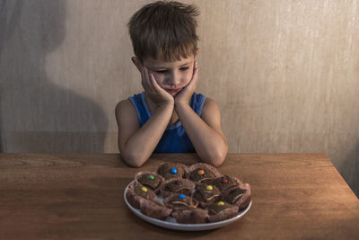 Portrait of boy looking at table