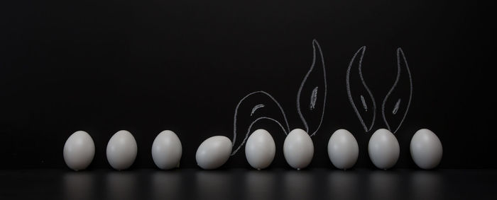 Close-up of candles over black background