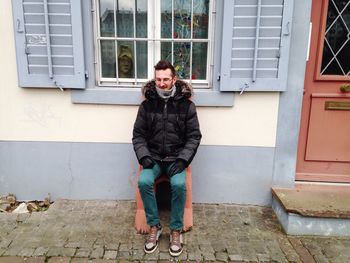 Portrait of young man standing on wall