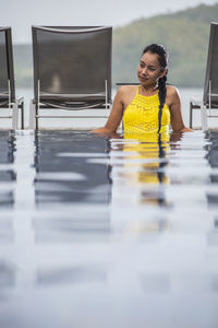 Beautiful woman enjoying a relaxing time in the pool of luxury resort