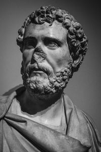 Close-up portrait of statue against black background