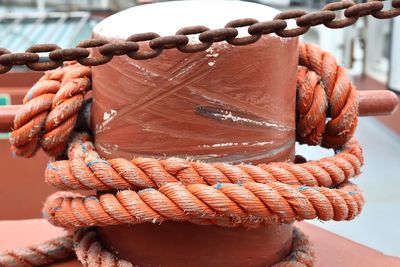 Close-up of rope tied on metallic bollard