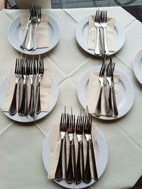 Close-up of forks in plate on table