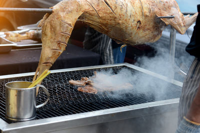 Person working on barbecue grill