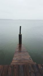 Pier over sea against sky