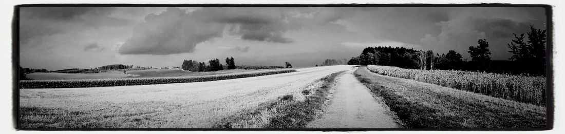 Panoramic view of road against sky during winter