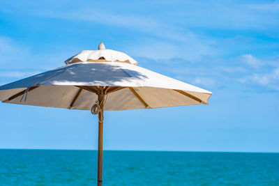 Built structure on beach against blue sky