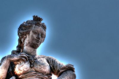 Low angle view of statue against clear blue sky