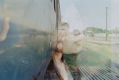 Double exposure of thoughtful woman and train