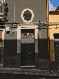 Telephone booth against built structure