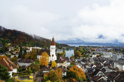 High angle view of cityscape against cloudy sky