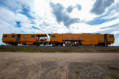 Train at railroad station against sky