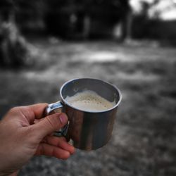 Person holding coffee cup