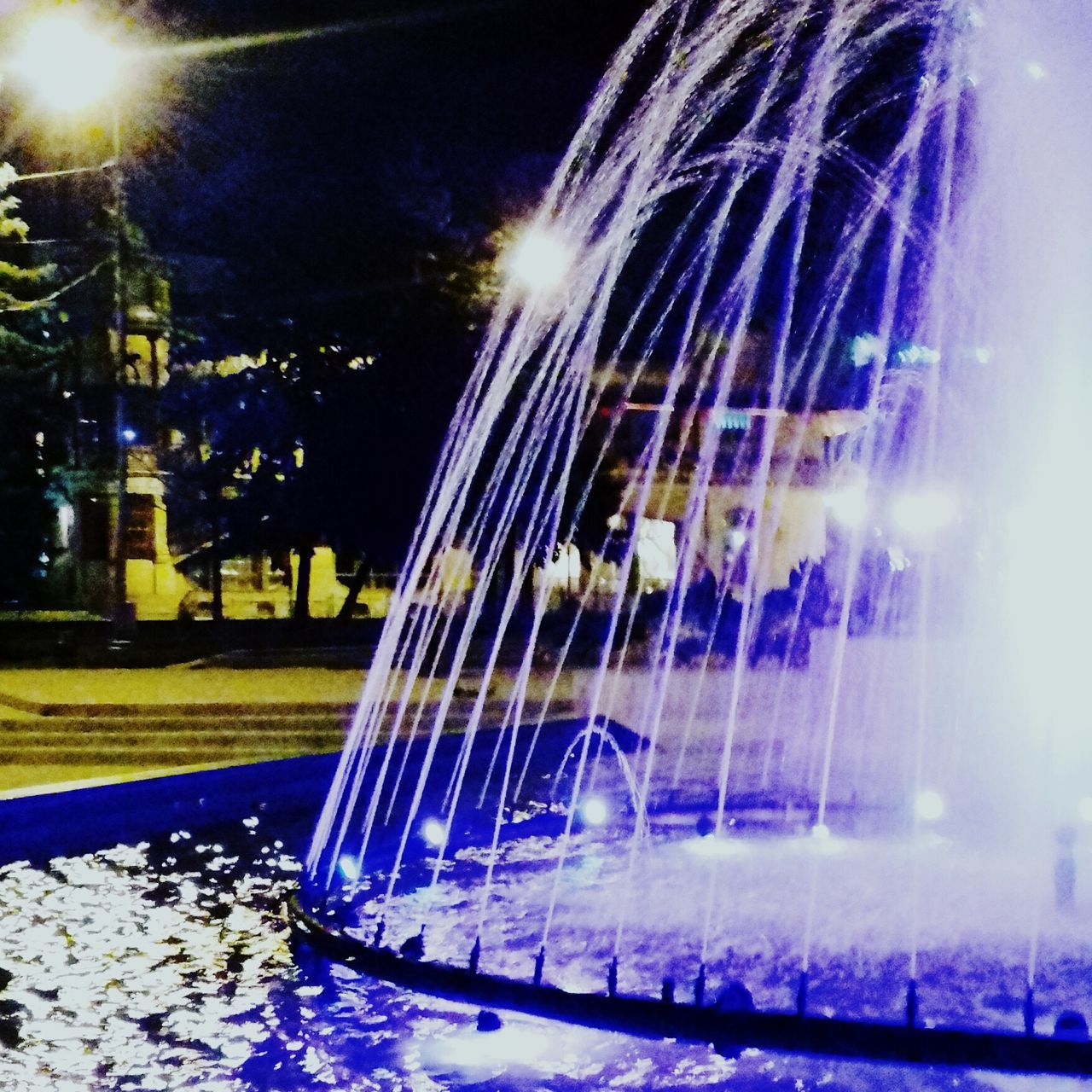 ILLUMINATED FOUNTAIN IN CITY