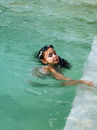 Young woman swimming in sea