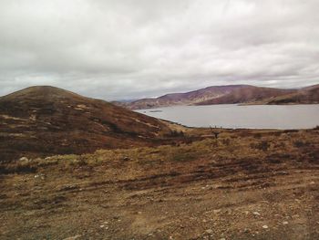 Scenic view of mountains against cloudy sky