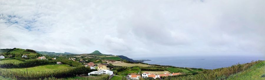 Panoramic view of townscape by sea against sky