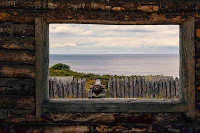 Scenic view of sea against sky seen through window