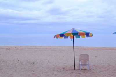 Lifeguard hut on beach against sky