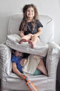 Young woman sitting on sofa at home