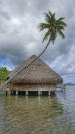 Scenic view of beach against cloudy sky